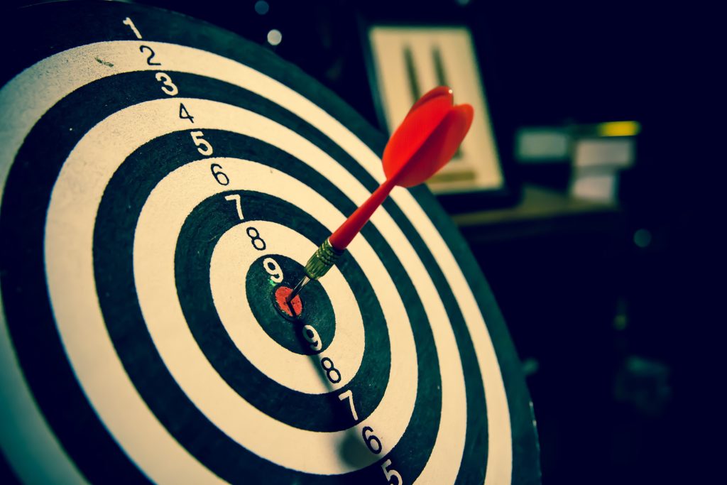 a red arrow in the middle of a bull's eye, hitting a target